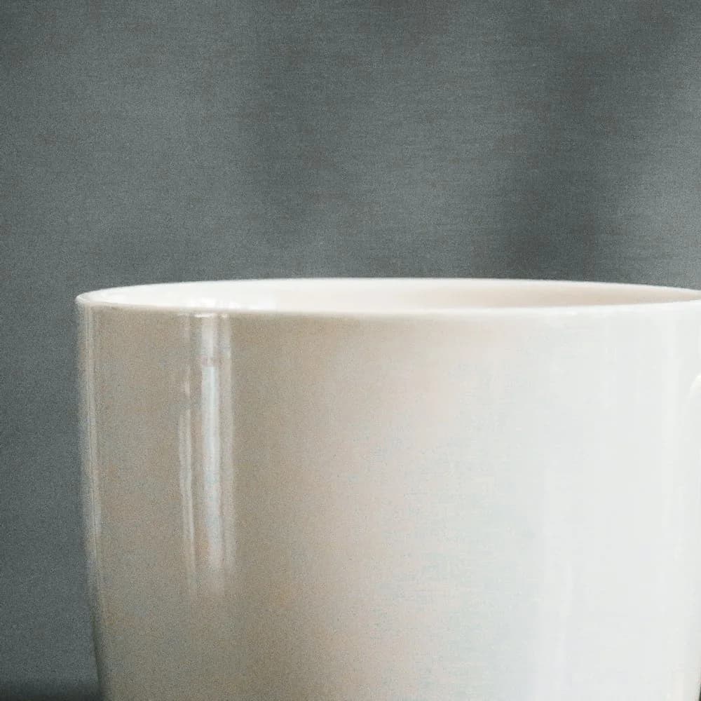 Stoneware mug with gold-glazed handle, close-up